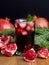 Glass of Pomegranate Juice with Ice and Fresh Pomegranate Fruits on Wooden and Black Backgroud Healthy Detox Drink Christmas Drink