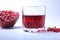 Glass with pomegranate juice Pomegranate seeds and Beautiful ripe pomegranate on white background with place for copy
