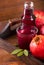 Glass of pomegranate juice on a wooden background