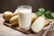 Glass of potato milk and raw potatoes close up. Alternative plant based milk. Vegan, healthy food. AI generated
