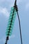 Glass powerline insulator disks against blue sky background