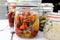 Glass preserving jars of pickled chillies, onions and gherkins o