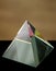 Glass prism as a pyramid with colorful reflections