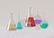 Glass products. Colored liquids in realistic glass flasks, measuring medical equipment. 3d illustration