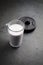 Glass of protein shake with milk and bilberries and and plates. Nutrition for bodybuilding.