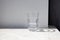 Glass of pure water on a granite table against white wall