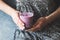 Glass of purple blueberry smoothie in woman`s hands