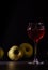 A glass of red fruit wine isolated on black. Apples fresh crop, still life in a low key.