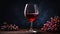 Glass of red semi-sweet wine on dark background.