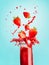 Glass of red strawberry splash summer beverage: smoothie or juice standing at blue background with copy space for your design,
