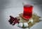 Glass of red tea and cube of sugar with red flowers looks nise a