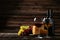 Glass of red and white wine, cheeses and grapes on the brown wooden background