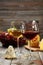 Glass of red and white wine, cheeses and grapes on grey wooden background