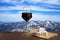 Glass of red wine against mountains background. Closeup view of glass of red wine over snowy mountains