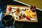 Glass of Red Wine and Assortment of Cheese on a Wooden Tray