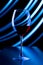 Glass with red wine on a background of abstract lines of light