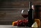 Glass of red wine, cheeses and grapes on a grey wooden background