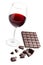 Glass with red wine and chocolate bar