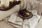 Glass of red wine and fruits in the bowl with a red rose and book