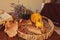 Glass of red wine with pumpkins, books and dried leaves