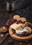 Glass of red wine with selection of various cheese on the round board and grapes on wooden background. Blue Stilton, Red Leicester