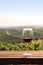 Glass of red wine on the terrace above the vineyard, Vertical format 2:3