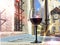 Glass of red wine under street golden watches in cafe  old house ,summer on medieval city Tallinn Estonia travel Europe