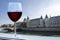 Glass of red wine with view on riverbank of Seine and Conciergerie in Paris