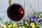 Glass of red wine with yellow flower petal