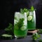 Glass of refreshing green drink with cucumbers and mint leaves on a table