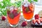 Glass of refreshing iced tea with strawberries and mint, horizon