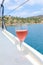 A glass of rose wine on the deck for the beginning of a summer holiday on a yacht in the Aegean Sea