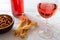 Glass of rose wine with savoury party snacks and wine bottle on