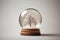Glass snow globe with frozen snowy trees inside. Magical Christmas crystal ball, minimalist crystal magic ball with trees. Xmas