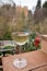 Glass of Spanish dry white wine served on outdoor terrace with view on red walls of Andalusian fortress Alhambra in Granada, Spain