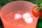 Glass with sparkling water and frash bright strawberries in a summer garden. Shallow depth of field. Selective focus