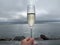 Glass of sparkling wine in pool of Sky Lagoon, geothermal bath in Reykjavik, Iceland.