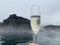 Glass of sparkling wine in pool of Sky Lagoon, geothermal bath in Reykjavik, Iceland.