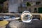 Glass sphere lying on a rusty bollard