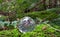 A glass sphere rests on a bed of moss