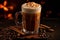 glass with spiced latte, cinnamon sticks, coffee beans and pumpkin on a dark background.