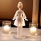 Glass statuette of a girl in a dress with candles