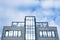 Glass and steel facade of a modern office building with large windows reflecting the sky, Munic, Germany