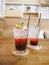 Glass of strawberry juice with soda on wooden table