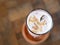 a glass of strawberry latte on a wooden table. top view