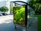 Glass structure bus shelter in urban setting. advertisement and commercial.