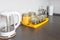 Glass stylish vintage jars with different food and teapot in Interior of the modern kitchen in loft flat apartment in minimalistic