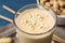 Glass of tasty banana smoothie with peanuts, closeup