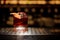 Glass of tasty fresh and strong whiskey cocktail decorated with orange peel on bar counter