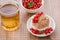 glass of tea, cake is decorated with berries and a plate with currant/glass of tea, cake is decorated with berries and a plate